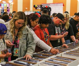 Collectors browsing long rows of cards laid out on vendor tables