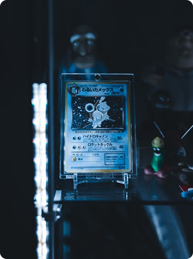 A vintage holographic card displayed in a lit cabinet
