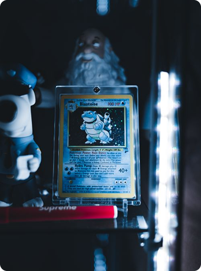A displayed Blastoise holographic card in a collector's cabinet